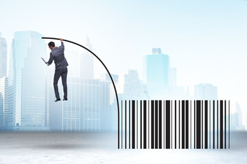 Businessman jumping over bar code in pole vaulting