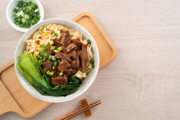 Beef noodle soup. Taiwanese famous food in a bowl on wooden table.