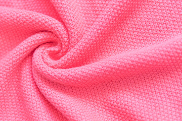 Gentle light pink textured jersey sweater folded surface as background