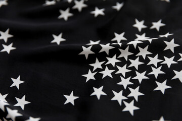 Black folded fabric with white stars pattern as texture background