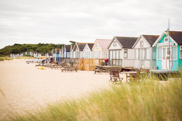 Beach huts on sandy beach, Hengistbury Head, Dorset, UK