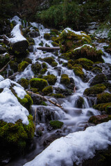 Fototapeta na wymiar A waterfall between snowy rocks in Conguillio