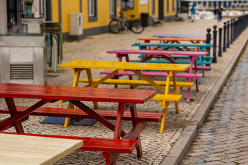 Fototapeta na wymiar Aligned colorful wooden tables