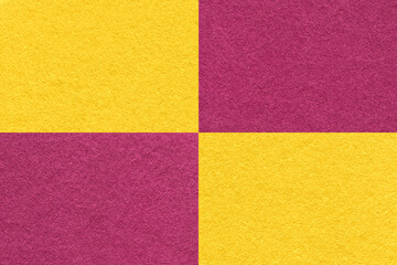 Texture of craft yellow and wine paper background with cells pattern, macro. Vintage kraft golden and purple cardboard.