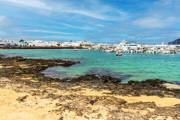 Fototapeta na wymiar Beach and port in Caleta del Sebo, La Graciosa, Canary Islands, Spain