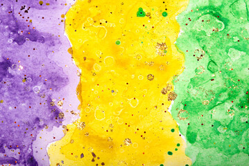 Watercolor background for Mardi Gras party. Fat Tuesday Holiday. Celebration greeting card. Purple, yellow and green colours with gold sequins. © Anna