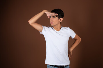 A man gesticulates against the background in the studio. Greetings, hands to the side.