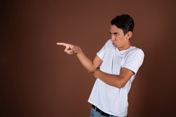 Offended student looks away. Male envy. Pink background.