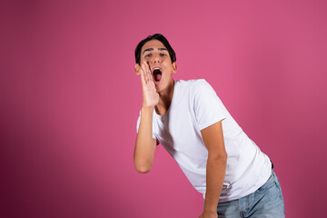 A man gesticulates against the background in the studio. Greetings, hands to the side.