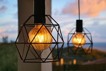 Hanging lamps with modern big bulbs inside the cozy home interior.