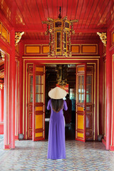 Woman in Ao Dai inside of Imperial Royal Palace of Nguyen dynasty in Hue, Vietnam
