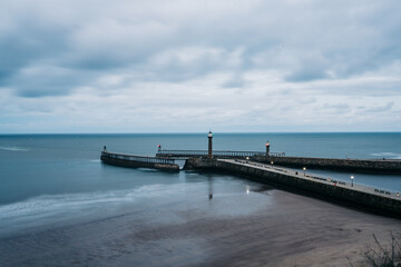 Fototapeta na wymiar Whitby Harbour and lighthouse on the pier