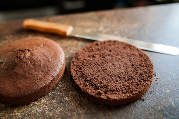 cut chocolate sponge cake on the table