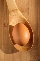 chicken egg on a wooden spoon