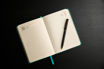 open notebook written book with pen