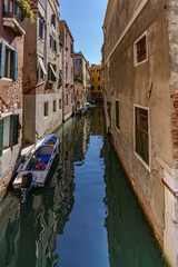 A view of the narrow Venetian water channels winding tightly between the buildings