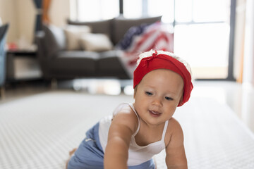 Patriotic holiday. Cute caucasian baby ten-eleven months old with blonde hair and blue eyes with...