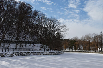 The peaceful winter scenery fully covered lake with the powder white snow at the forest park in Sapporo Japan