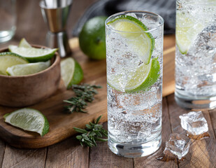 Gin and tonic cocktail with lime and ice - 567357015