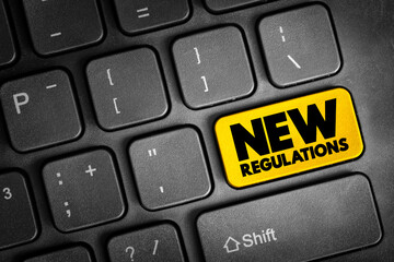 Fototapeta premium New Regulations text button on keyboard, concept background