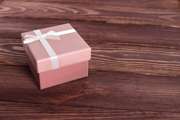 Gift box on wooden background, copy space