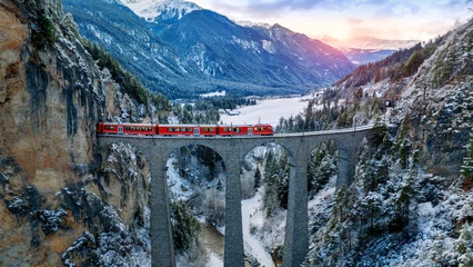 Peel and stick wall murals Landwasser Viaduct Aerial view of Train passing through famous mountain in Filisur, Switzerland. Landwasser Viaduct world heritage with train express in Swiss Alps snow winter scenery.