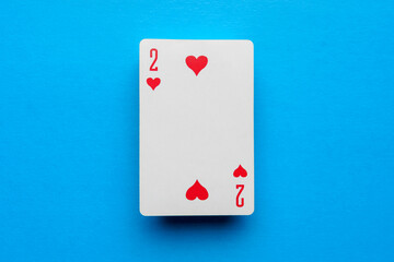 Playing card deuce of hearts on a blue background