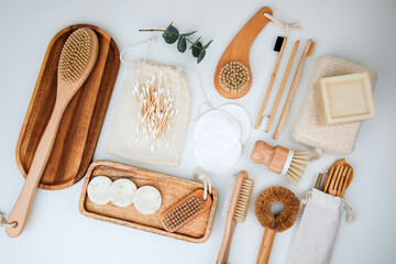 Fototapeta na wymiar Set of wooden eco friendly devices. Brushes, washcloth and ear sticks, natural soap on a white background. Flat lay
