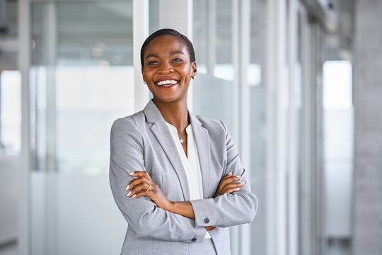 Cheerful mid adult business woman smiling at office