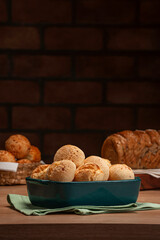 Cheese breads in a serving dish with breads behinden.