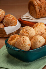 Cheese breads in a serving dish with breads behinden.