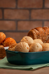 Cheese breads in a serving dish with breads behinden.