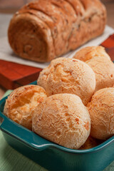 Cheese breads in a serving dish with wholemeal bread behinden.