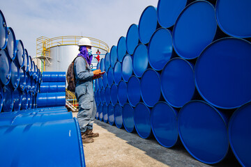 Male worker inspection record drum oil stock barrels blue horizontal or chemical