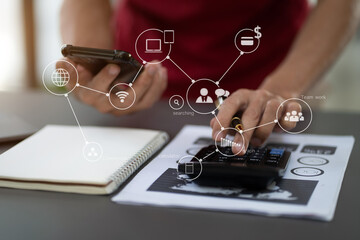 male businessman working with holding a pen and using a calculator to calculate the numbers of...