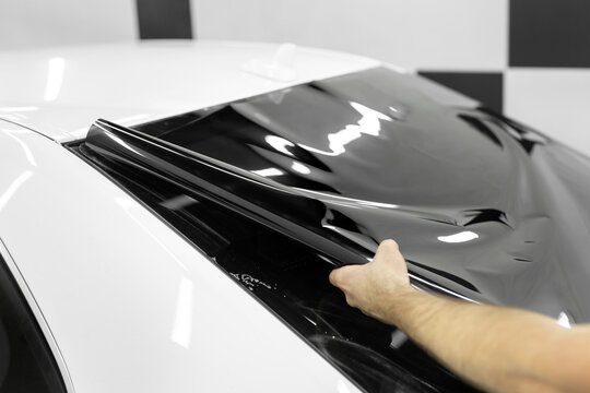 Car window tinting series: Installation of car window tinting. Detailing studio.