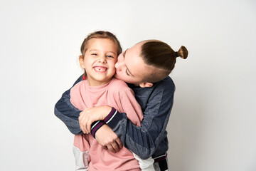 Boy and girl hugging each other on white background