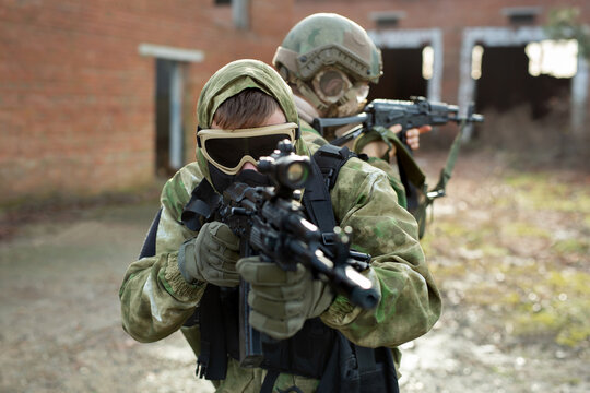 Two military man with airsoft automatic rifle.