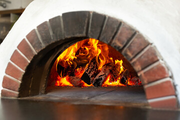 Open fire and coals in stone stoves. Oven made of brick and clay on firewood. Pizza oven. Brick oven