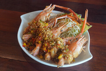 Top view hot Stir Fried Prawn with Chili and Salt Add chili, salt, seasoning, shredded cabbage Placed in a white ceramic plate, placed on the table.