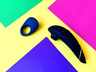 Clitoral sucking vibrator and cock ring. Sex toys, sex shop assortment. Flat lay © Olga Goretz