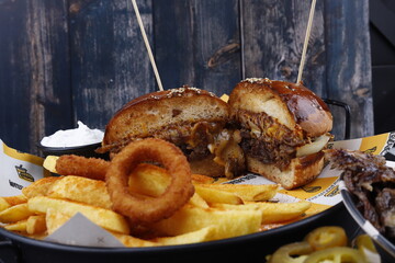 Hamburger with fries and onion rings