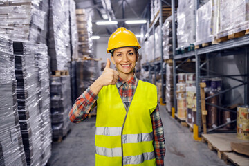 A storage worker is giving thumbs up for full commodity reserves in facility.