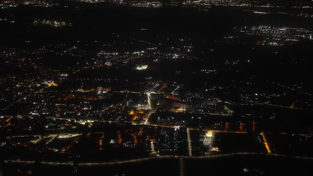 View of the night city and streets from the plane.