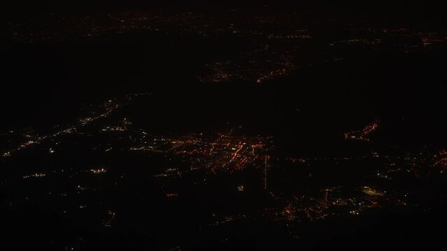View of the night city and streets from the plane.
