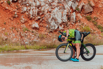 A professional triathlete preparing for a training ride on a bicycle
