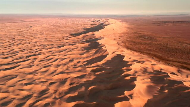 Aerial flyover sand dunes Khongoryn els in Gobi desert in Mongolia.