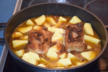 Schweinebacuhpfanne mit Apfelsauce und Kartoffeln, noch kochend