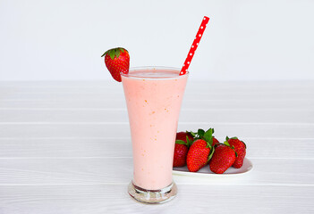 Strawberry yogurt fruit juice smoothie pink colorful fruit juice milkshake blend beverage healthy high protein the taste yummy In glass drink episode morning on white wood background.