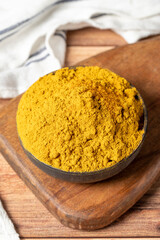 Curry Masala Powder. Turmeric powder or curry powder spice in a bowl on wooden background. İndian spices. Dry spice concept. close up